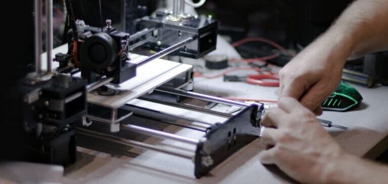 A man is demonstrating his 3D printing process
