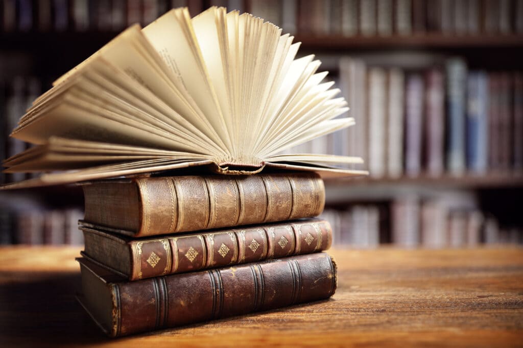 books on top of each other, with the first on the top opened