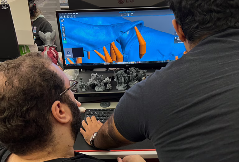 Loot's team creating and placing the supports on our minis before sending them to our community