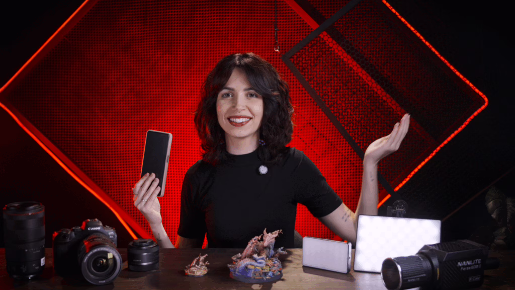 Loot Studios' photographer with a table full of photography items to take a good miniature picture.