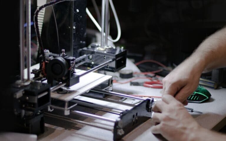 A man is demonstrating his 3D printing process