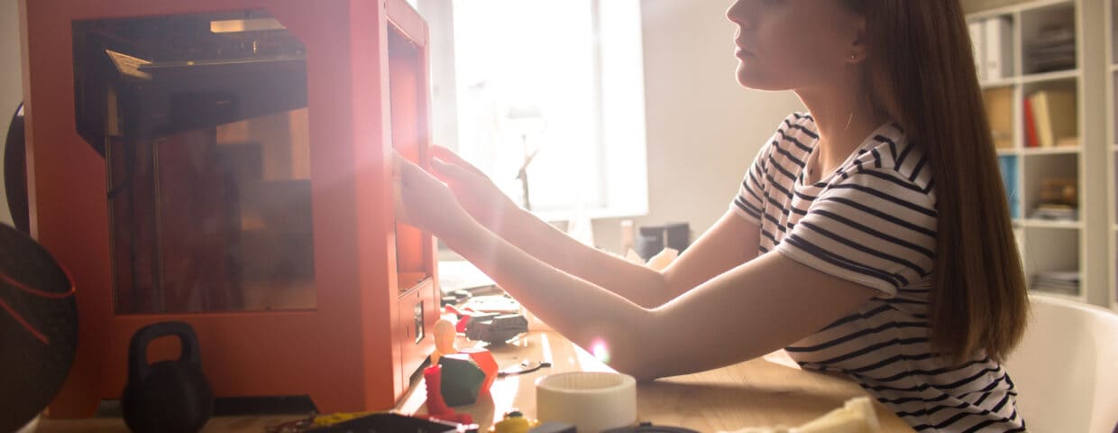 Woman loading a 3D printer