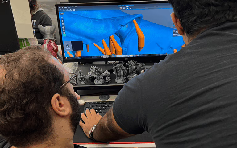 Loot's team creating and placing the supports on our minis before sending them to our community